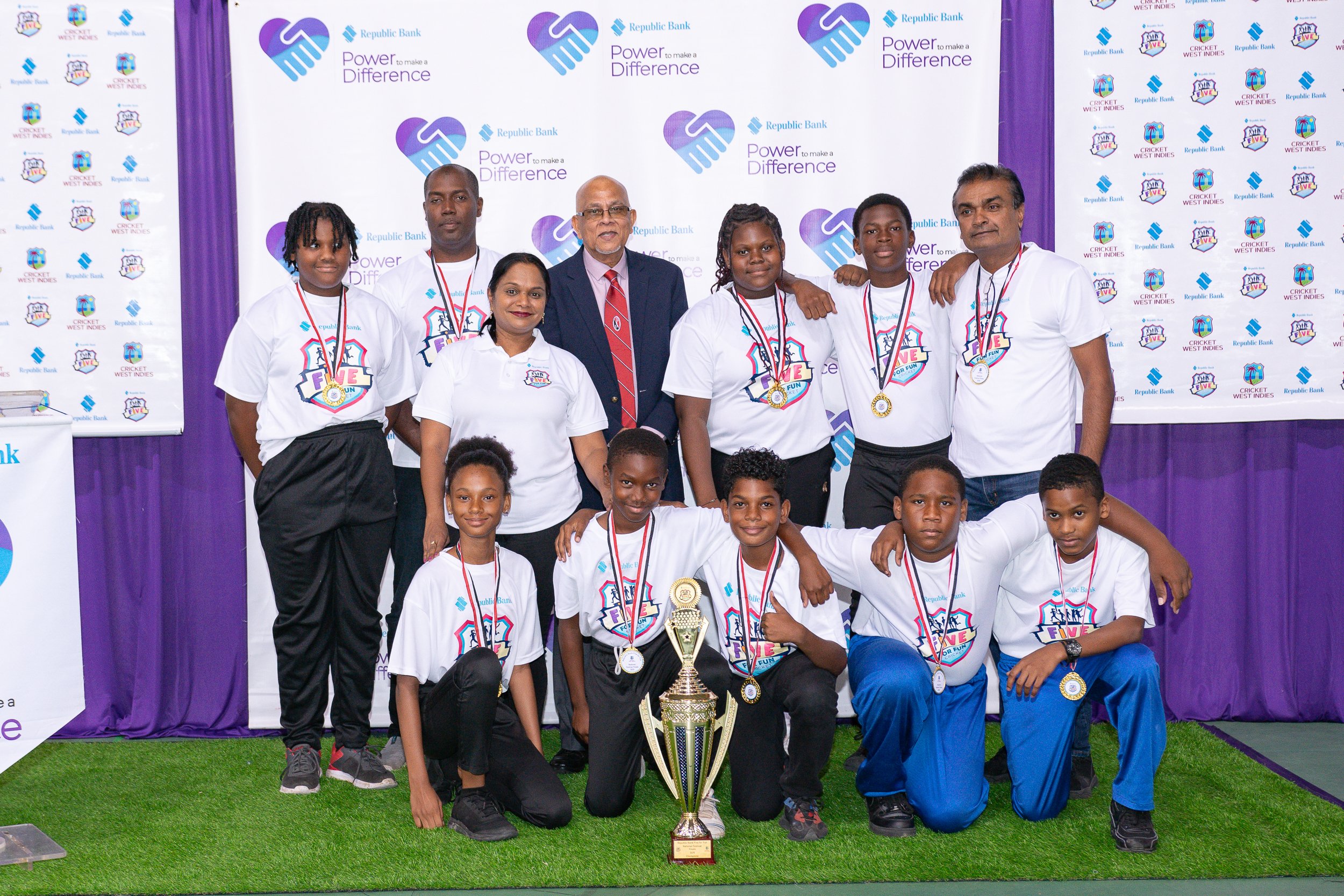 Photo 1 - National Republic Bank 'Five for Fun' Champions Longdenville Government pose for a photo with Mr. Azim Bassarath- CWI Vice President and TTCB President and Ms. Reena Gopaul Manager Group Brand Management of Rep